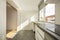 Semi-furnished studio with white kitchen cabinets, gray stone countertops,