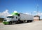 A Semi with Green Highlights and Wind Turbine