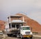 A semi hauling a houseboat over a bridge in arizona