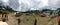 Semi panoramic view of busy Lukla Heliport in cloudy weather