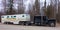 A semi pulling a trailer filled with horses from a farm in northern canada