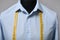 Semi-ready shirt with tailor`s measuring tape on mannequin against grey background, closeup