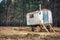 Semi trailer house with chimney and steps near pine trees