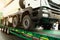 Semi-trailer transports a lorry. Transporting a heavy truck by semitrailer