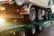 Semi-trailer transports a lorry. Transporting a heavy truck by semitrailer