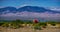 A semi truck drives east on interstate highway 10 across the summer desert in Arizona