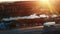 A semi truck driving on a highway into the sunset, front view aerial camera.