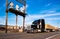 Semi Truck with timber near an electrical substation