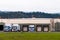Semi trucks blue trailers loading unloading cargo in warehouse b