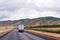 Semi trucks caravan going divided highway with silky Idaho mount
