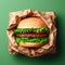 Semi-wrapped burger against green background