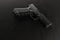 A semiautomatic pistol on a black background