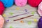 Semicircle of pastel colored yarn on the wooden table crochet hooks