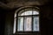 A semicircular arch window in an old abandoned building