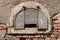 Semicircular old window on an old brick wall