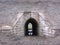 Semicircular stone arch under the embankment a passage under the mountain a tunnel