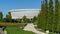 Semicircular terraces with sage go down to rows of trimmed Thuja plicata Western red cedar on Stadium Krasnodar background