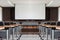 Seminar room with a speaker table in the middle of the stage and whitescreen background