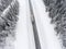 Semitrailer track driving through the blizzard on wintry highway, top view from drone