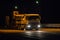 Semitrailer Transport the Excavator along the Night Highway