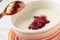 Semolina with red currant jam in a bowl