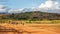 Sendrisoa, Madagascar - April 28, 2019: Group of unknown Malagasy men, women and children walking home after working at fields,