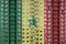 Senegal flag depicted in paint colors on multi-storey residental building under construction. Textured banner on brick wall