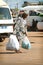 SENEGAL - JUNE 12: A woman walking in the street with big bags o