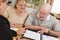 Senior Adult Couple Going Over Papers in Their Home with Agent