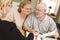 Senior Adult Couple Going Over Papers in Their Home with Agent