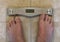 Senior Adult Feet on Bathroom Scales
