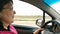 Senior adult woman with glasses, driving her car moves on road. Close-up portrait.