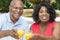Senior African American Couple Drinking Orange Jui