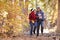 Senior African American Couple Walking Through Fall Woodland