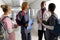 Senior african american male doctor talking to diverse trainee doctors in corridor at hospital