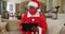 Senior african american man at christmas time wearing red face mask and santa costume