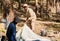 Senior African American man and his grandson putting tent in the forest