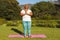 Senior african american woman with eyes closed practicing yoga in stunning countryside