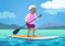 Senior African American woman on a stand up paddle board. Cute g