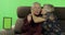 Senior aged man and woman sitting together on a sofa and talking. Chroma key