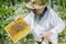 Senior apiarist in apiary making inspection