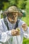 Senior apiarist checking bee pollen in apiary