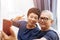 Senior Asian couple grandparents taking a selfie photo together at home.