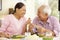 Senior asian couple sharing meal at home