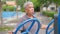 Senior Asian man in a casual workout in exercise stations in public park. Represents keeping young with physical activity, Open