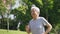 Senior asian man exercising jogging outdoors in park