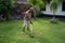 Senior asian man mowing grass at his own home garden