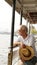 Senior Asian man riding a ferry boat to cross Chaopraya river i