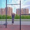 A senior asian man training on the sport ground in the city park on the background of a cityscape