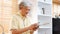 Senior asian man using smartphone at home background, Happy retirement asia male holding phone while standing in kitchen, Active